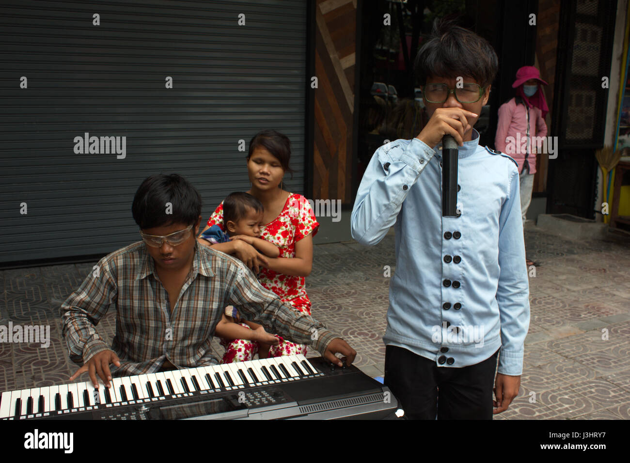 Blind musicians busking on Monivong Boulevard, Phnom Penh, Cambodia. Stock Photo
