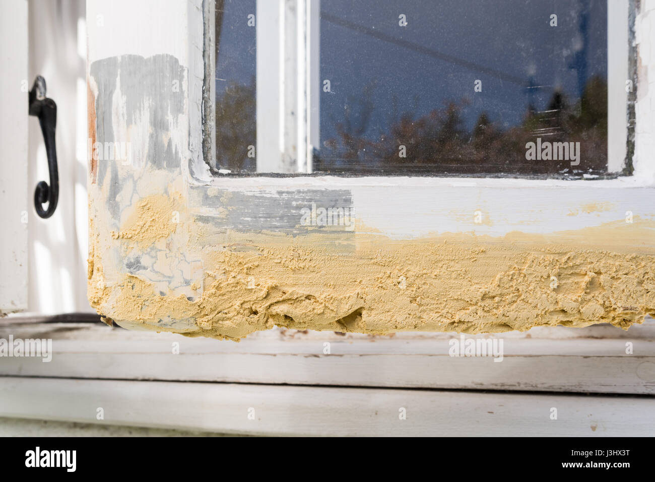 rotten wooden wood window - diy repair work with wood filler prior to sanding Stock Photo