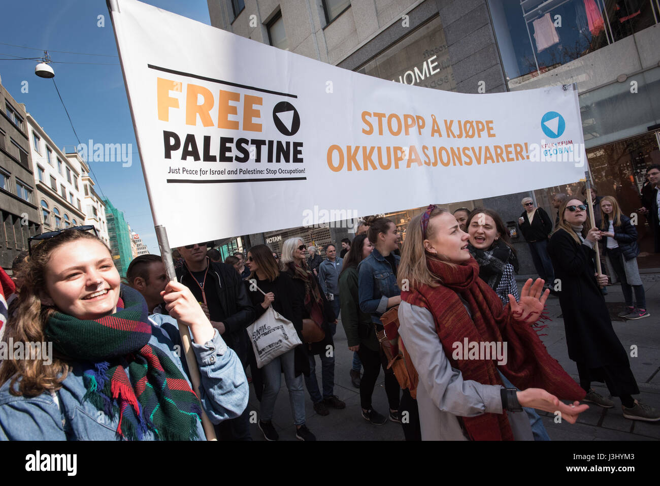 Activists carry a banner in English and Norwegian "Free Palestine