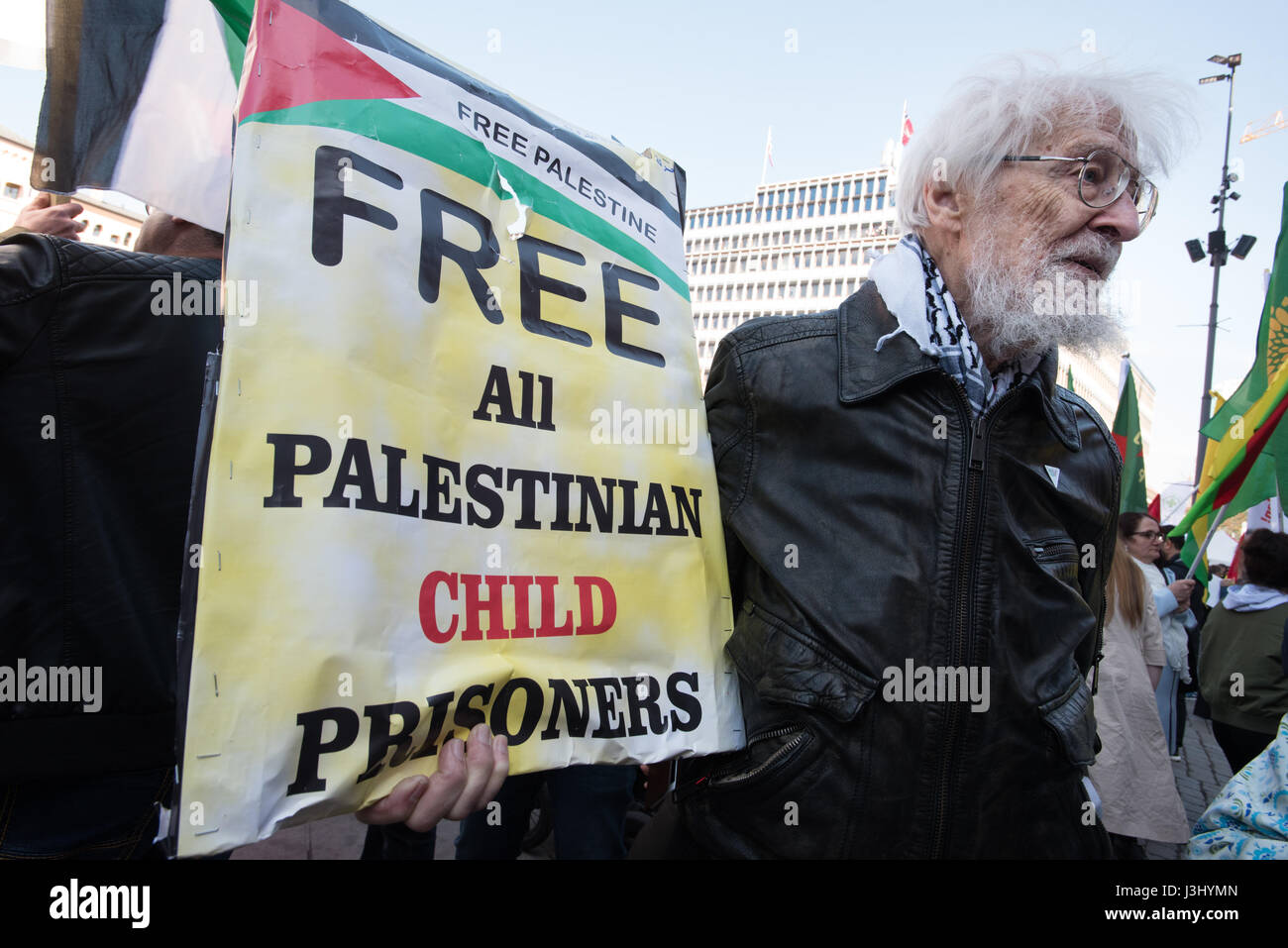 An activist holds a sign reading "Free All Palestinian Child Prisoners" at the annual May Day march in Oslo, Norway, May 1, 2017. Stock Photo