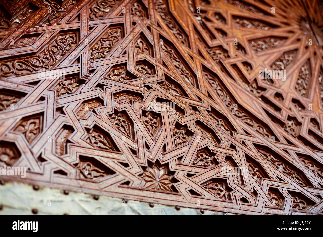 Moroccan architecture details an intricately carved wooden door Stock ...