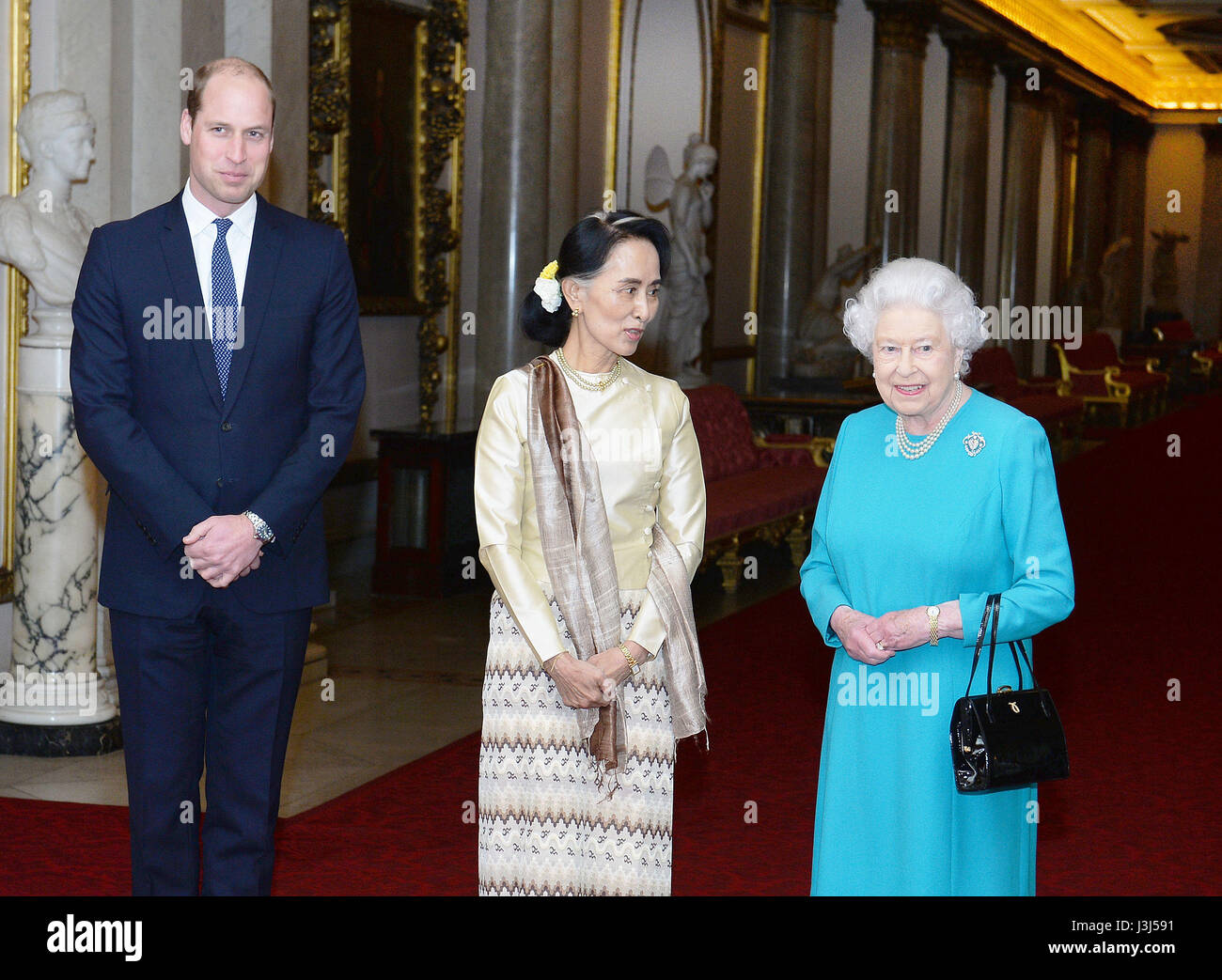 RETRANSMITTED CORRECTING LOCATION Queen Elizabeth II and the Duke of Cambridge greet Burma's de facto leader Aung San Suu Kyi ahead of a private lunch at Buckingham Palace in London. Stock Photo