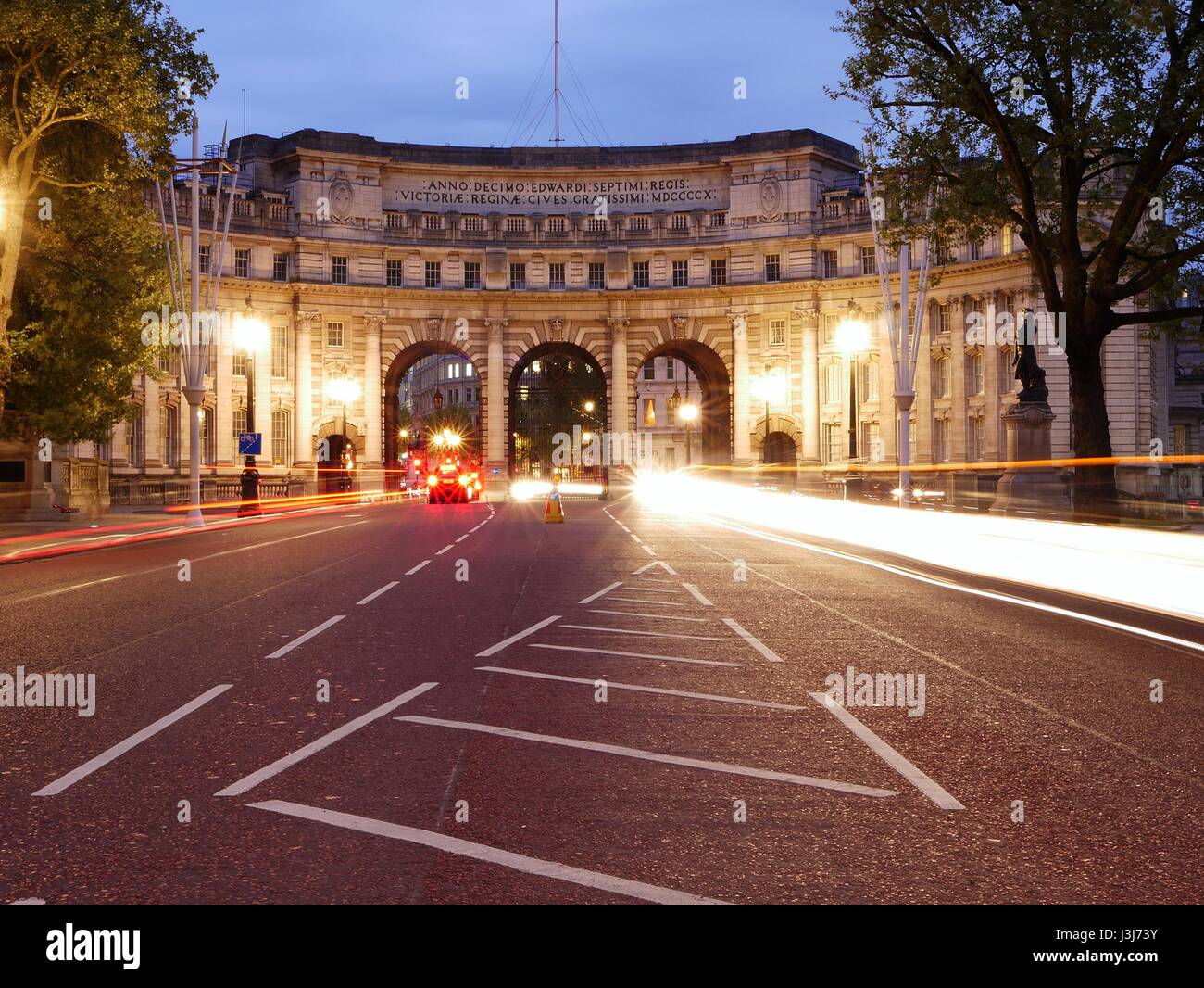 Admiralty Arch, nr. Trafalgar Square, London at night with traffic light trail Stock Photo