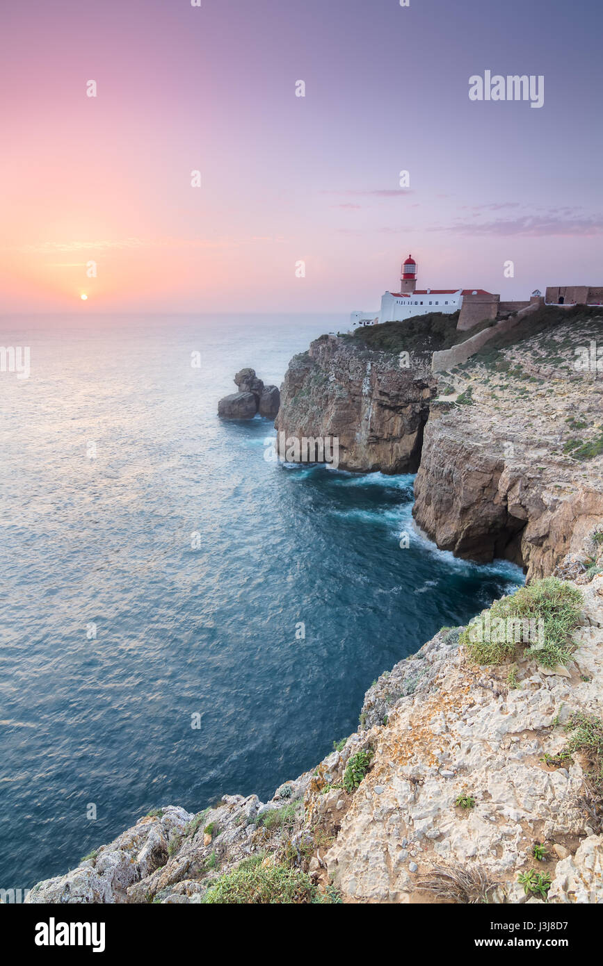 View of the lighthouse and cliffs at Cape St. Vincent at sunset ...