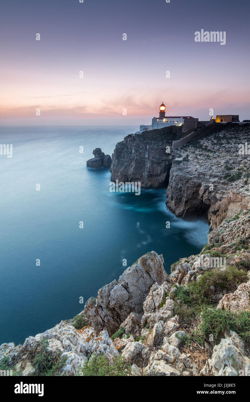 View of the lighthouse and cliffs at Cape St. Vincent at sunset ...