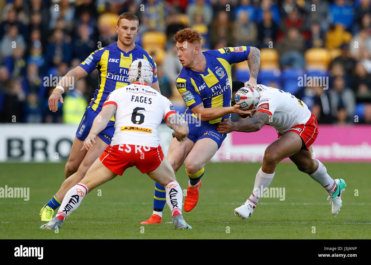 Warrington Wolves' Harvey Livett is tackled by St Helens' Zeb Taia during the Betfred Super League match at the Halliwell Jones Stadium, Warrington. Stock Photo