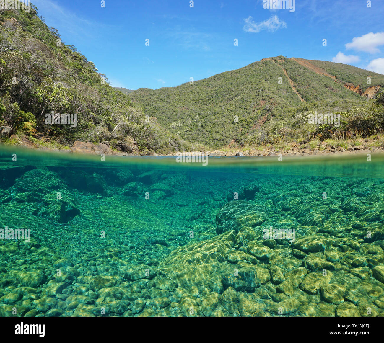 River landscape split view over under with a rocky riverbed underwater, Dumbea, Grande-Terre, New Caledonia, Oceania Stock Photo