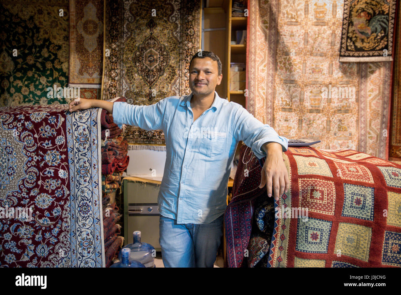 United Arab Emirates Man selling traditional rugs in Sharjah at the