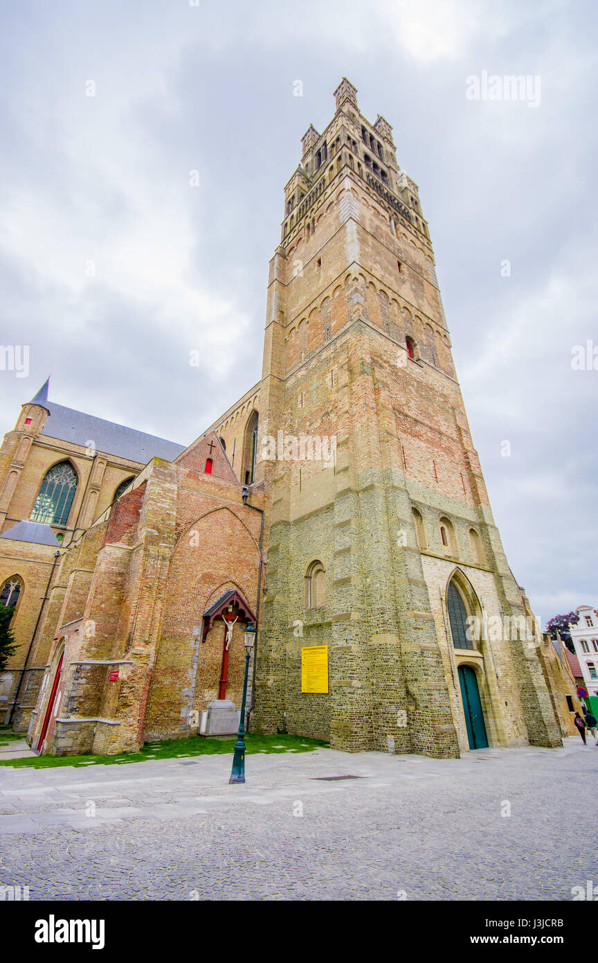 Bruges, Belgium - 11 August, 2015: Famous church Saint Salvator located in city centre  with its impressive tower. Stock Photo