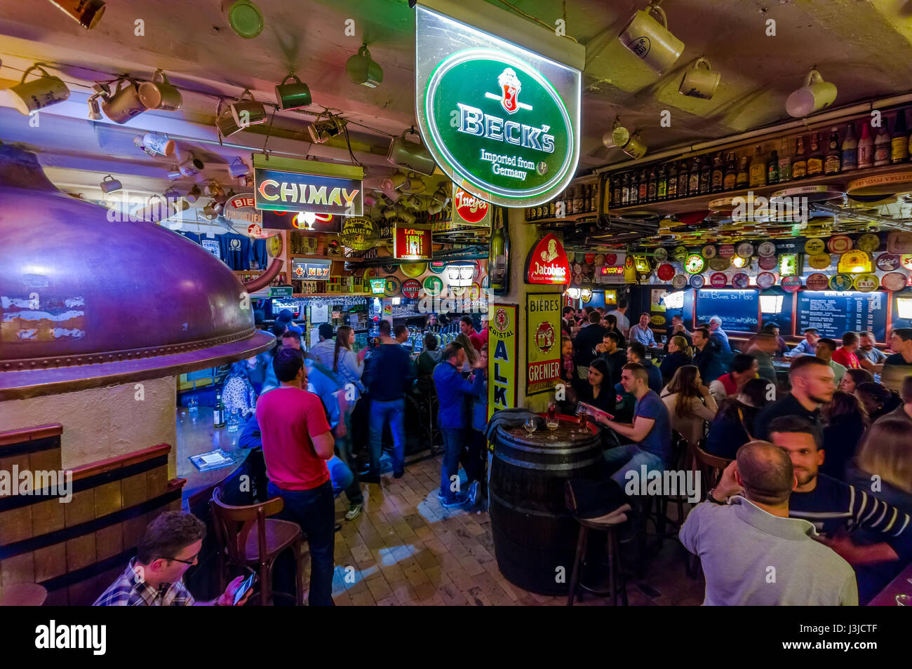 BRUSSELS, BELGIUM - 11 AUGUST, 2015: Famous Delirium Bar inside overview of crowded room of people enjoying their beers. Stock Photo