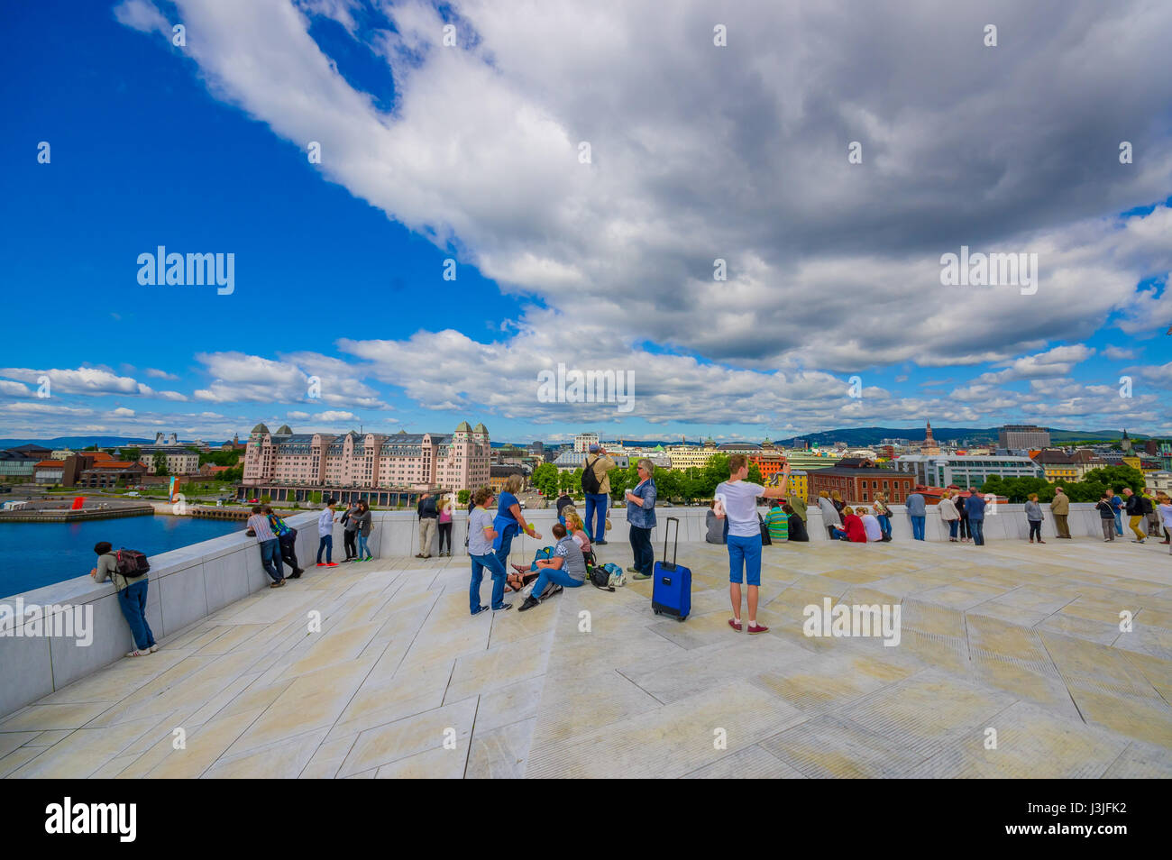 OSLO, NORWAY - 8 JULY, 2015: Walking on the spectacular opera house building located waterfront eastside of city with beautiful architecture and views Stock Photo