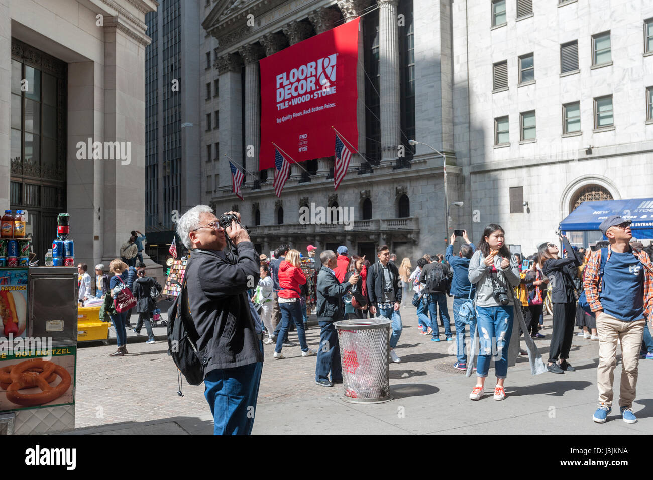 Hordes of tourists descend on the New York Stock Exchange, decorated for the first day of trading for Floor & Decor Holding's initial public offering on Thursday, April 27, 2017. Floor & Decor retails hard surface flooring such as laminate and tile as well as the accessories that go along with it.  (© Richard B. Levine) Stock Photo