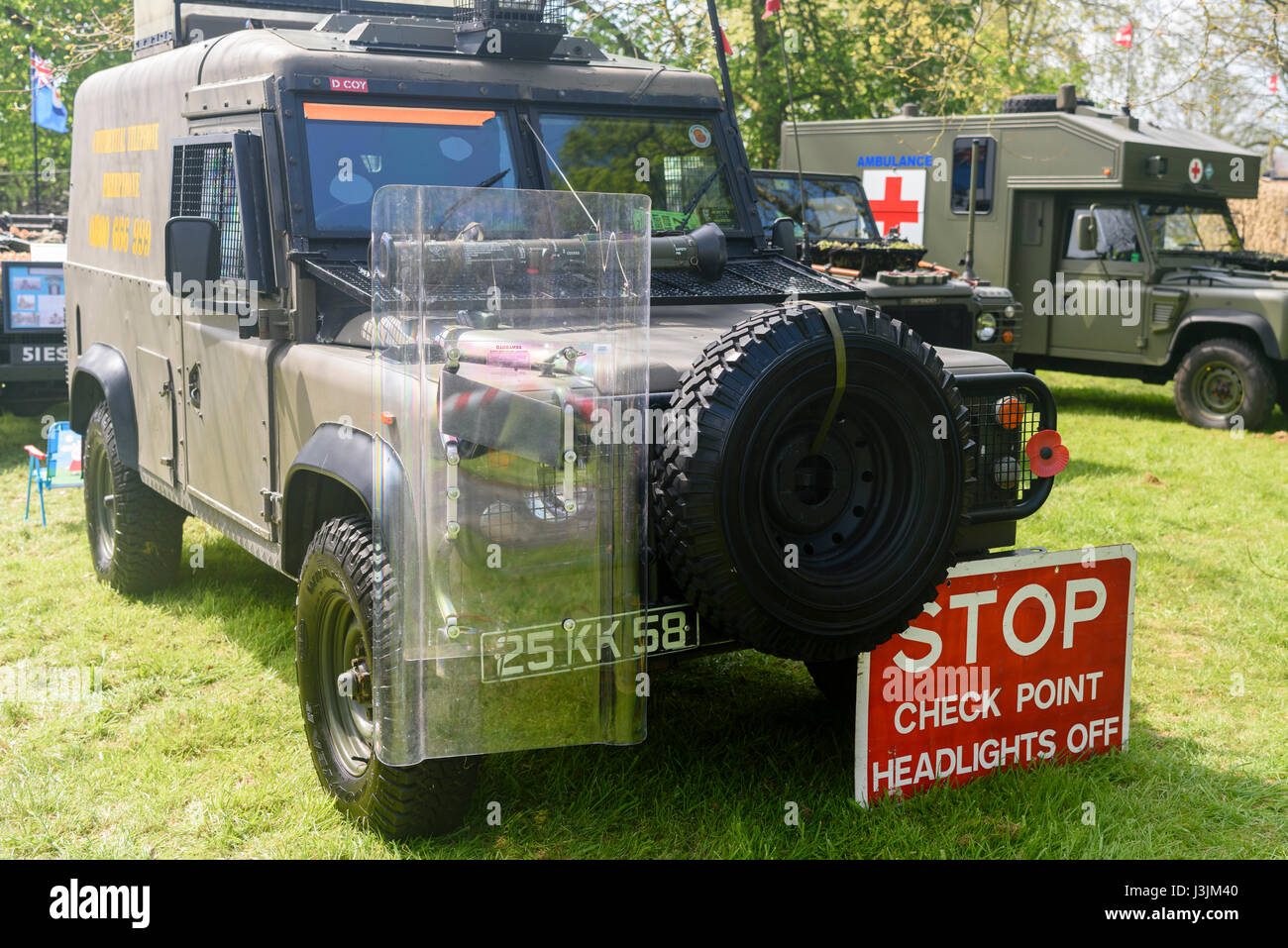 Army Landrover painted green, with a riot shield and 'STOP. Check point. Headlights off' sign, commonly seen during the Northern Ireland Troubles. Stock Photo