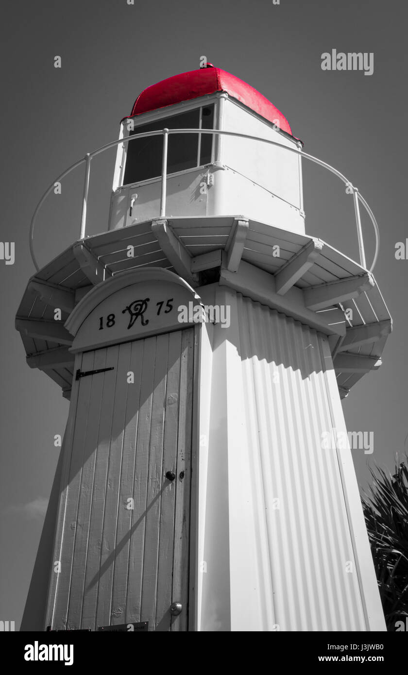 Selective colour picture of mini lighthouse at East Shores in Gladstone, with the red colour of the roof still showing. Stock Photo