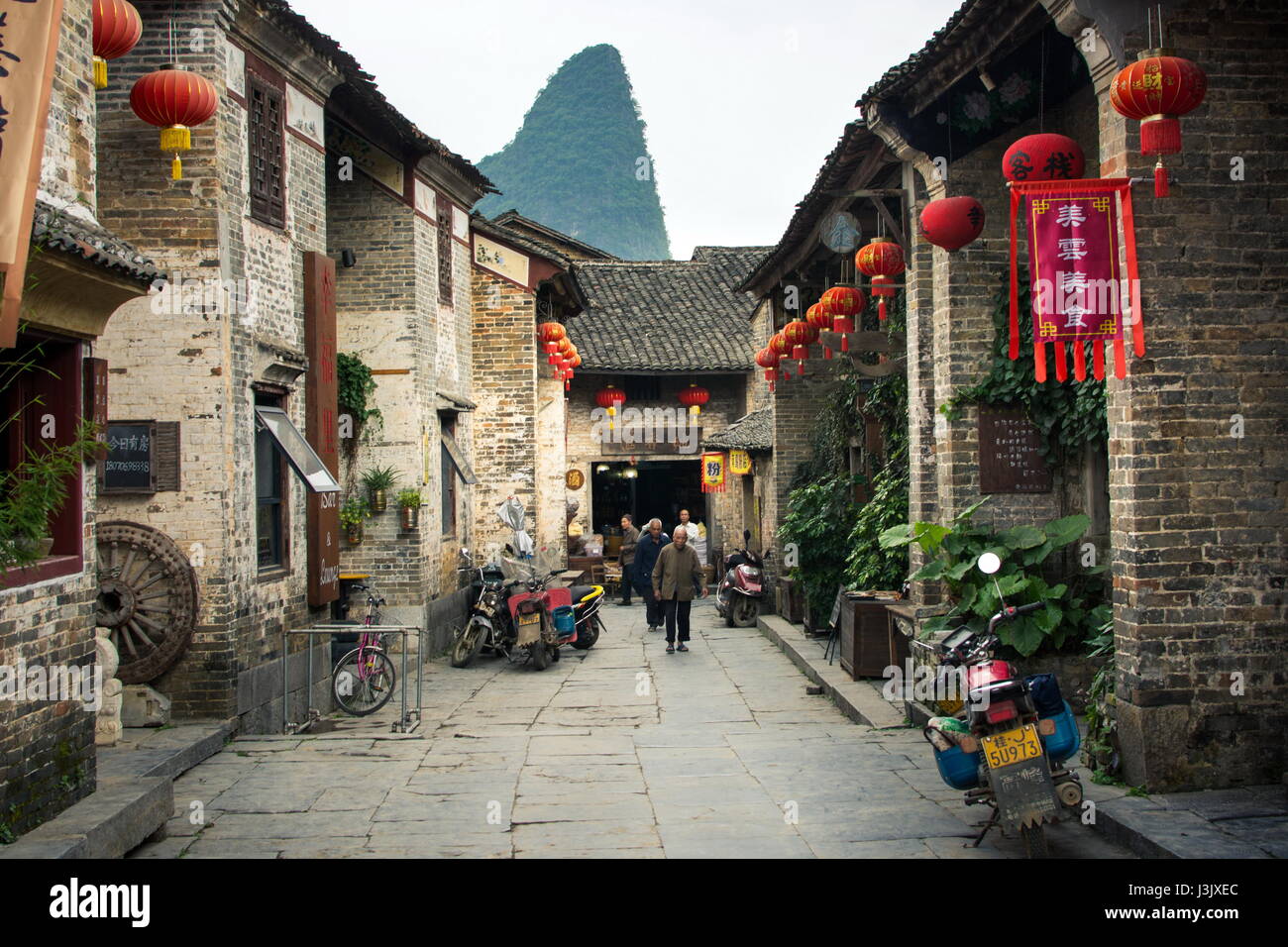 HUZHOU, CHINA - MAY 2, 2017: Residents of Huang Yao Ancient Town in Zhaoping county walking on the traditional Chinese style street Stock Photo