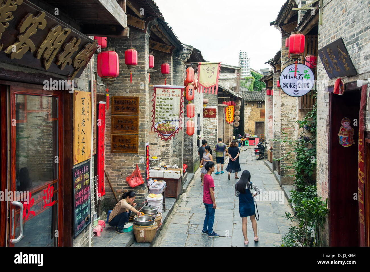 HUZHOU, CHINA - MAY 2, 2017: Tourists walking in the Huang Yao Ancient Town in Zhaoping county, Guangxi province. Traditional Chinese strry style Stock Photo