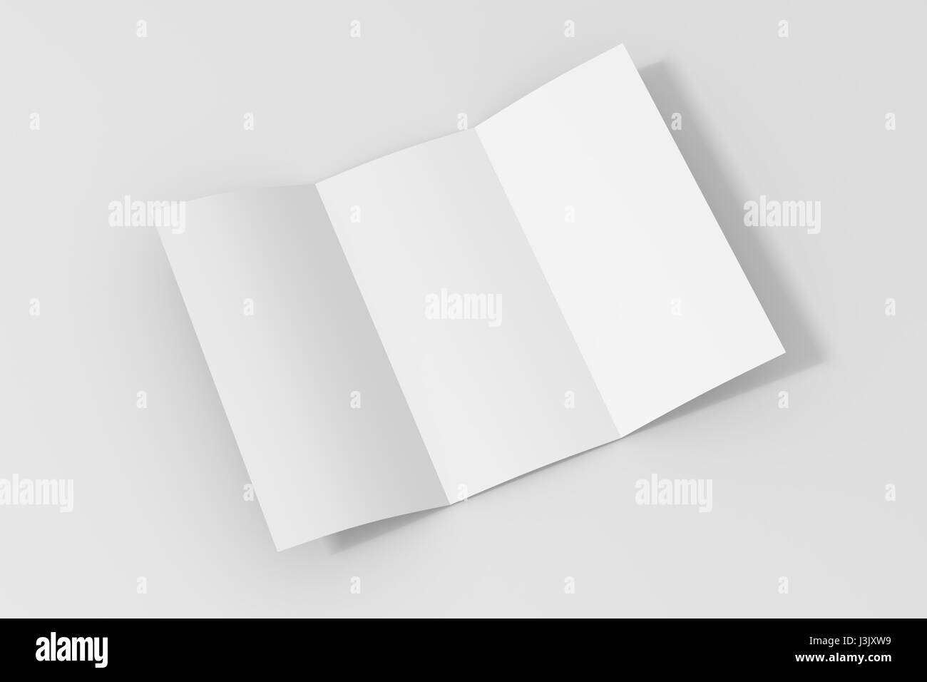 Blank three fold paper brochure on white background with soft shadows and highlights Stock Photo