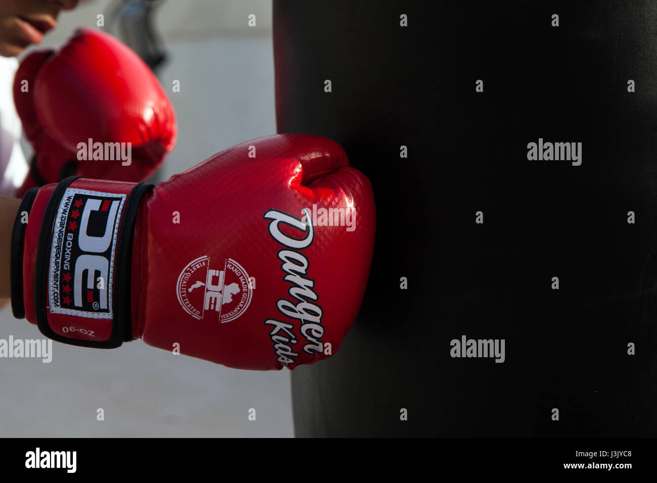 Young boxer with red boxing gloves hit punching bag Stock Photo Alamy