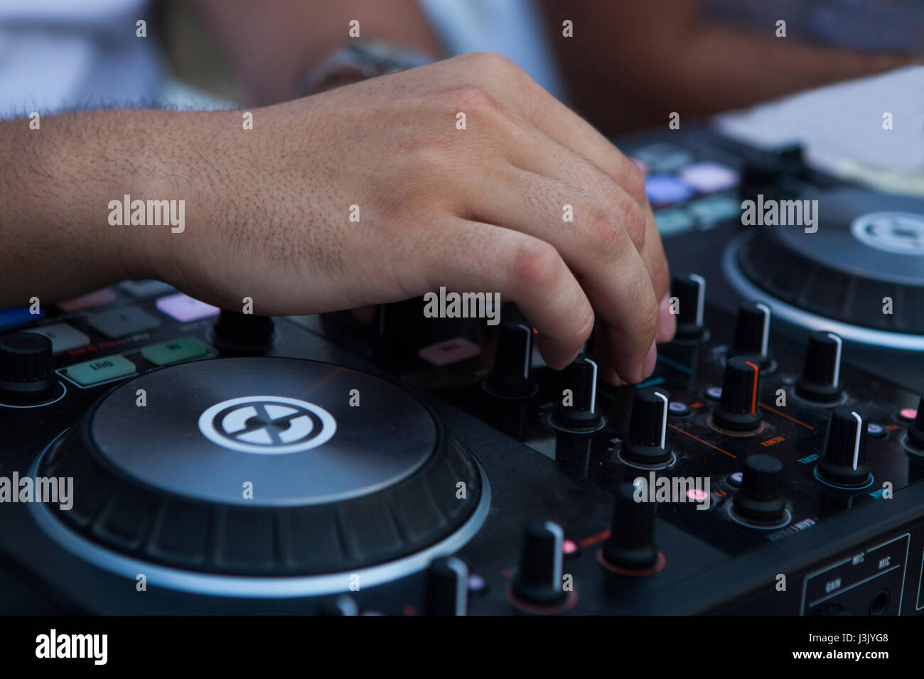 Operators hand on dj mixer controller Stock Photo - Alamy