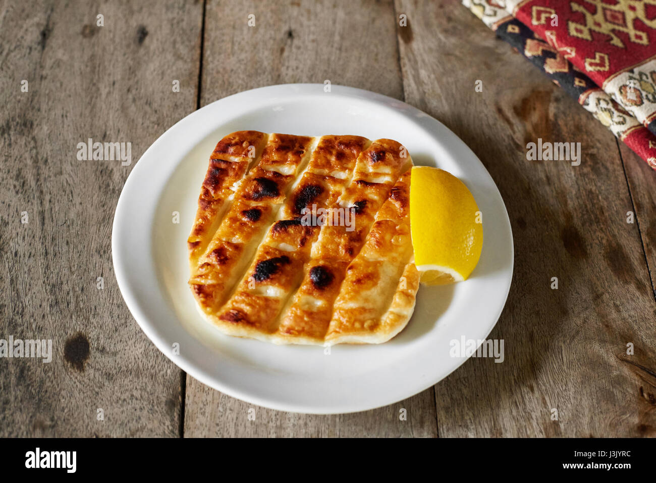 Grilled cheese with lemon. Stock Photo