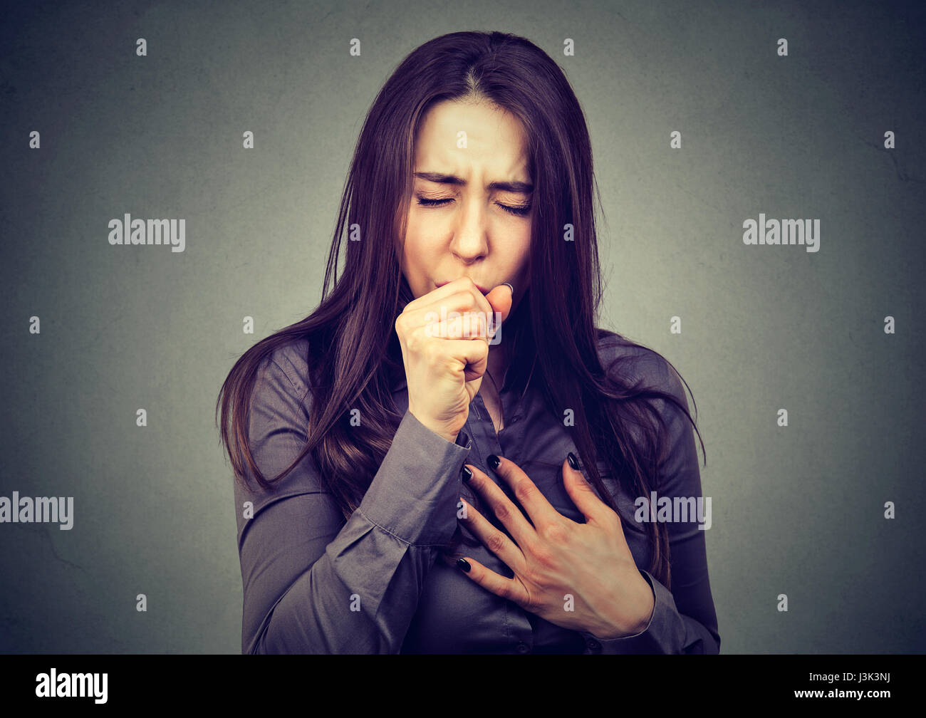 Woman coughing Stock Photo