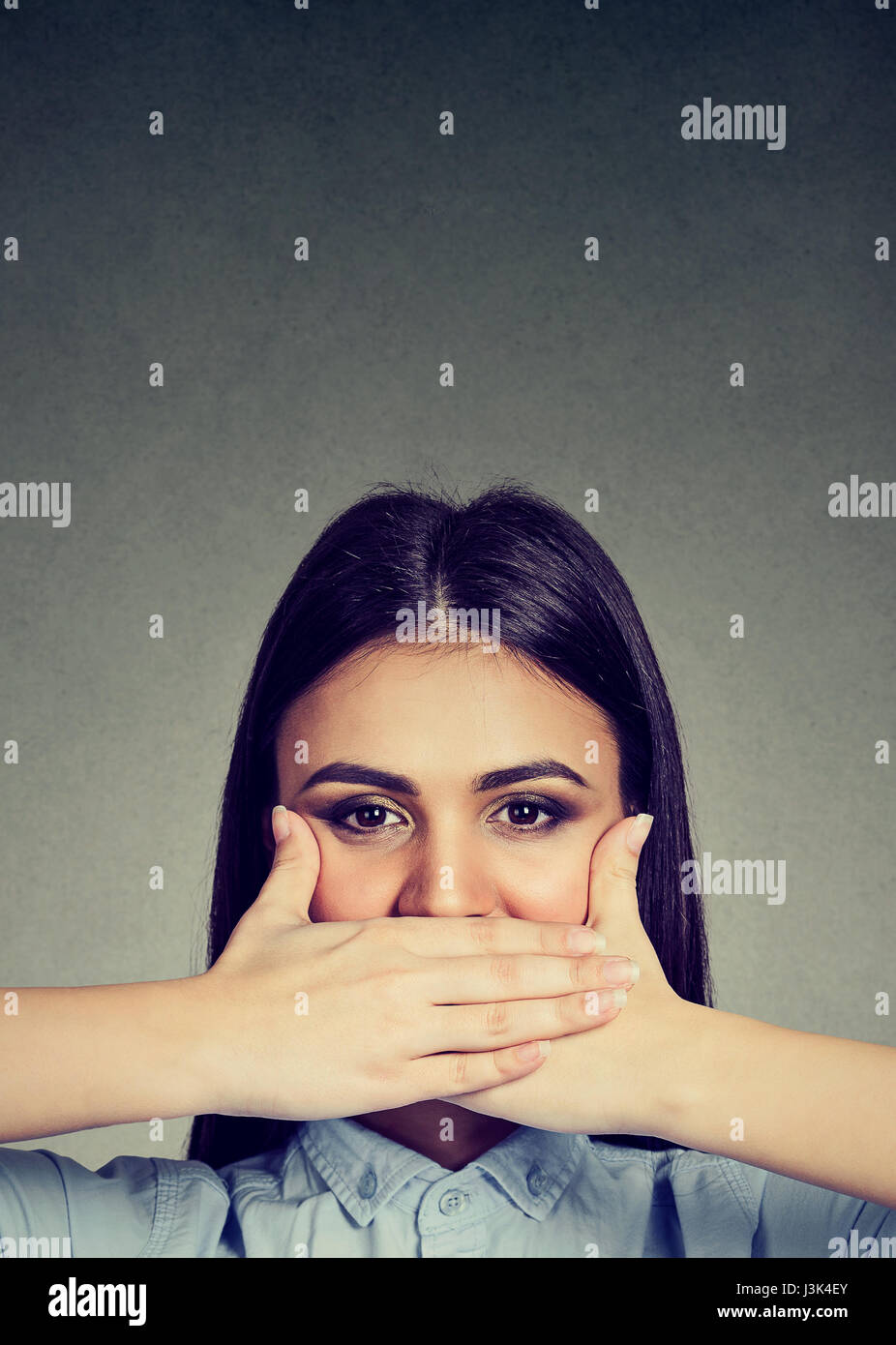 Young woman covering her mouth with hands Stock Photo Alamy