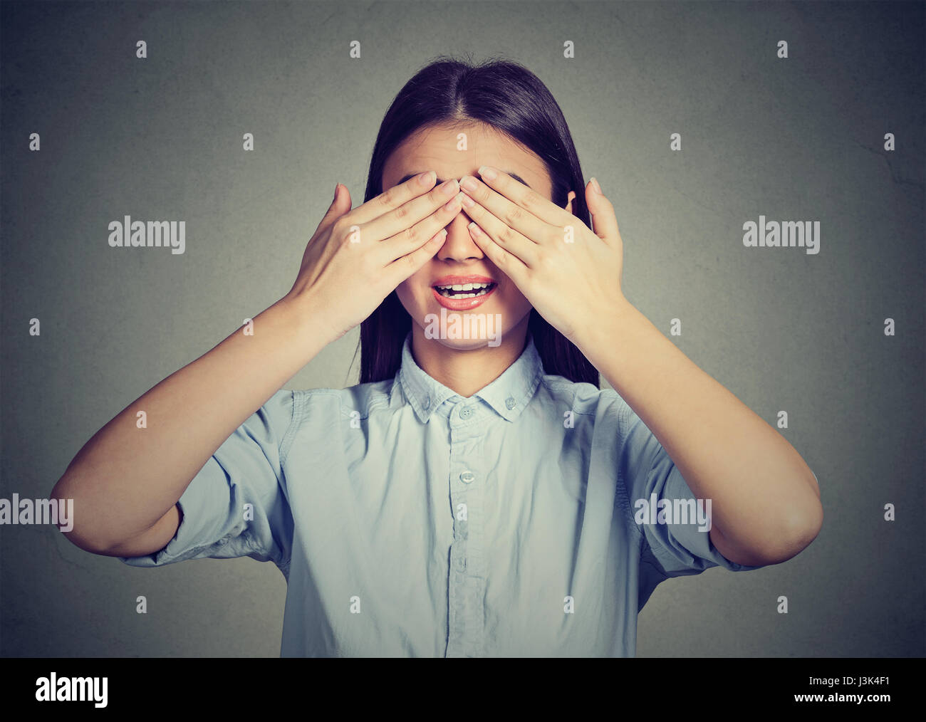 Laughing woman covering her face hires stock photography and images