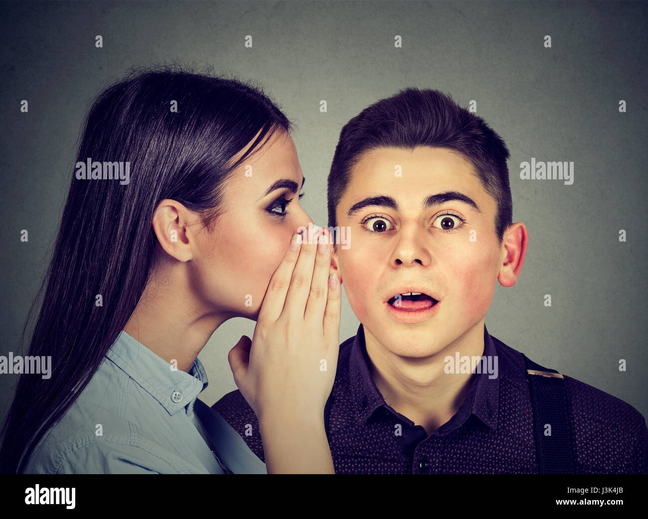 Latest rumors. Amazed man listening gossip in the ear Stock Photo