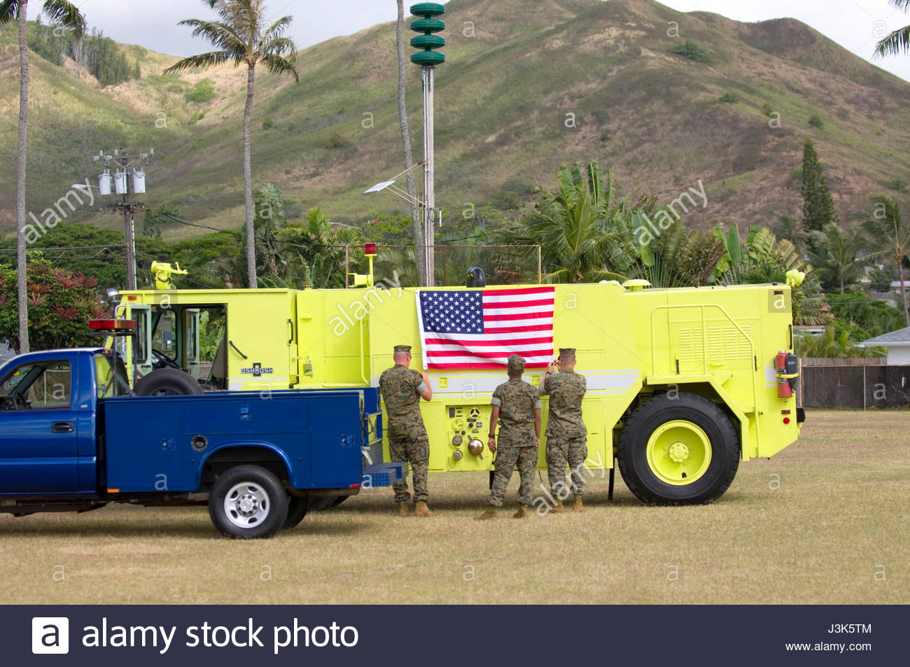 Solders Decorating Fire Truck With The American Flag Before The