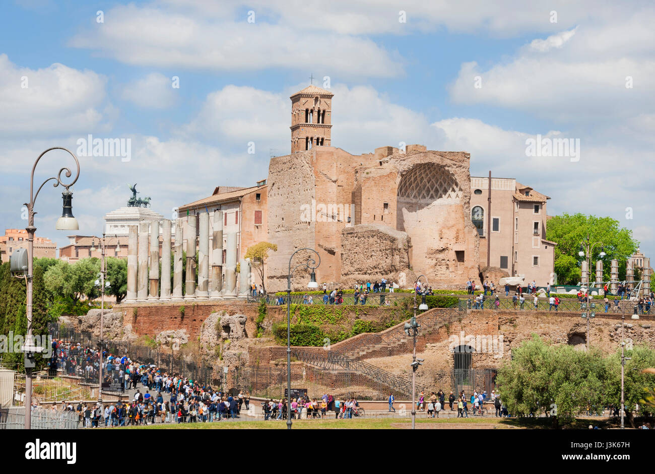 Tourists visit Rome central archaeological area with ancient Temple of Venus and Roma ruins Stock Photo