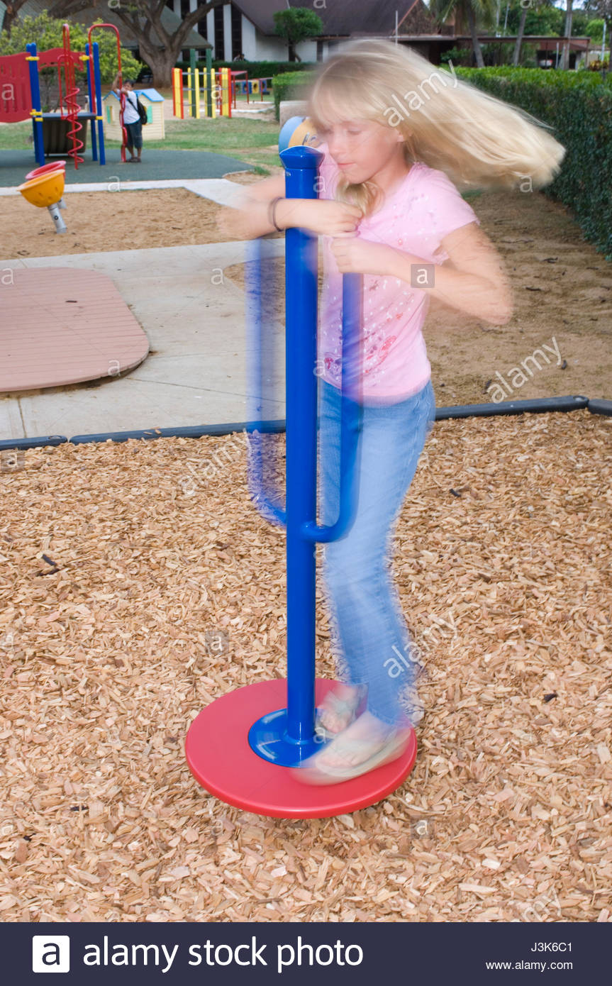 Young Girl Spinning On Playground Equipment Waiokeola Congregational Stock Photo Alamy