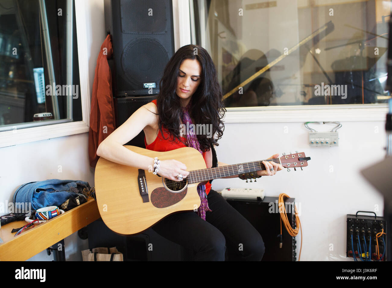 Young woman playing acoustic guitar at a recording studio Stock Photo ...