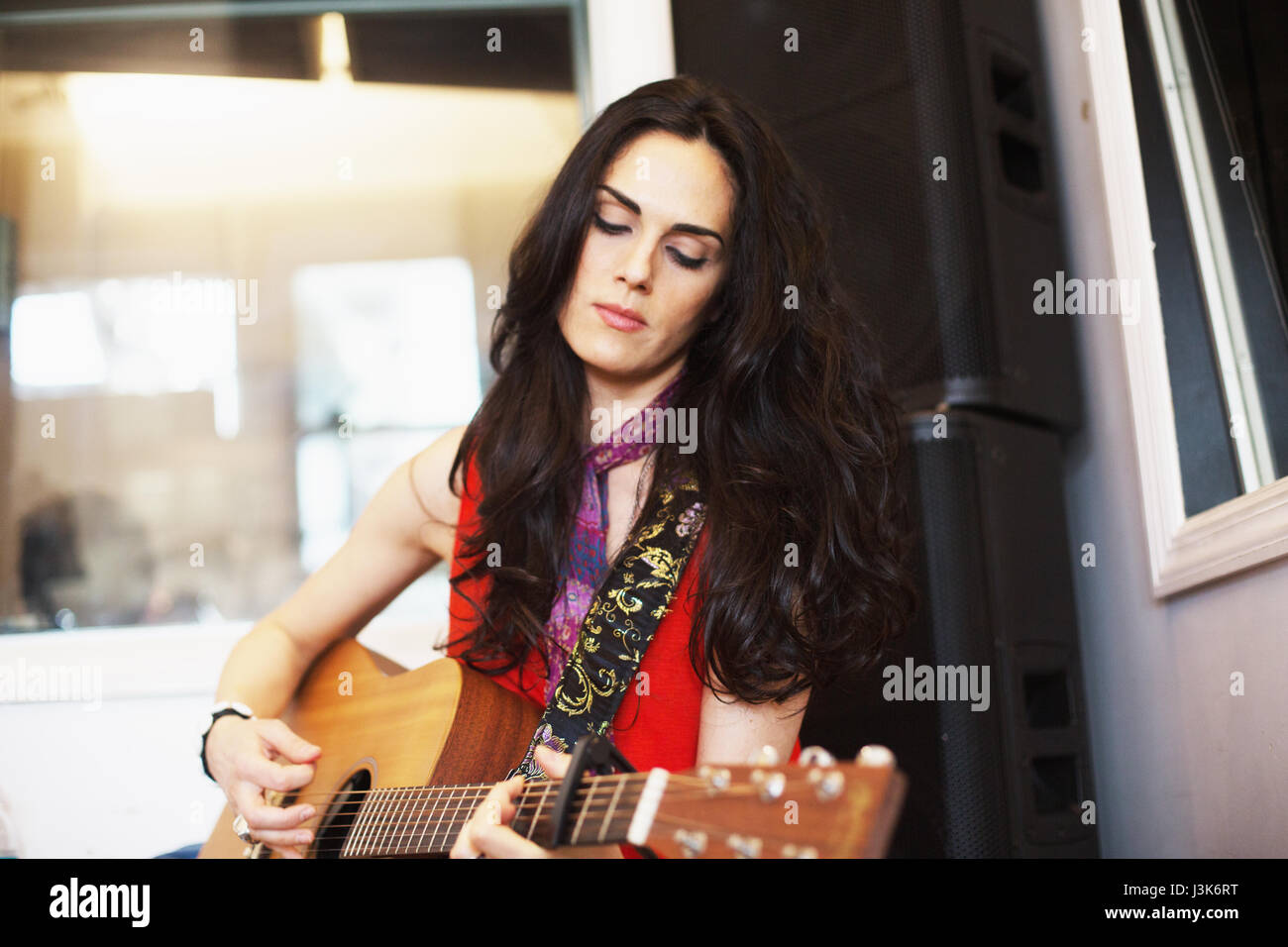 Young woman playing acoustic guitar at a recording studio Stock Photo ...