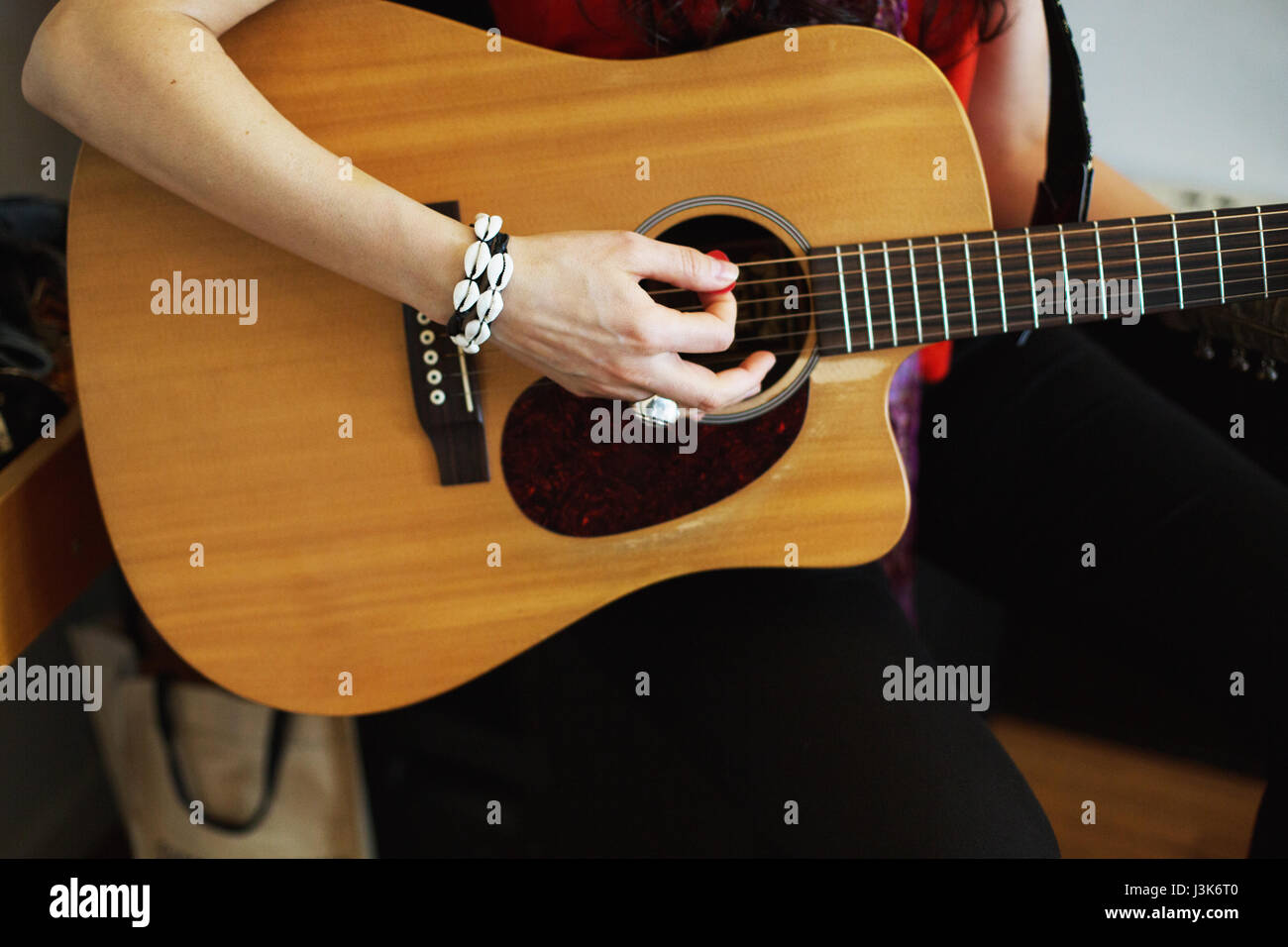 Young woman playing acoustic guitar at a recording studio Stock Photo ...