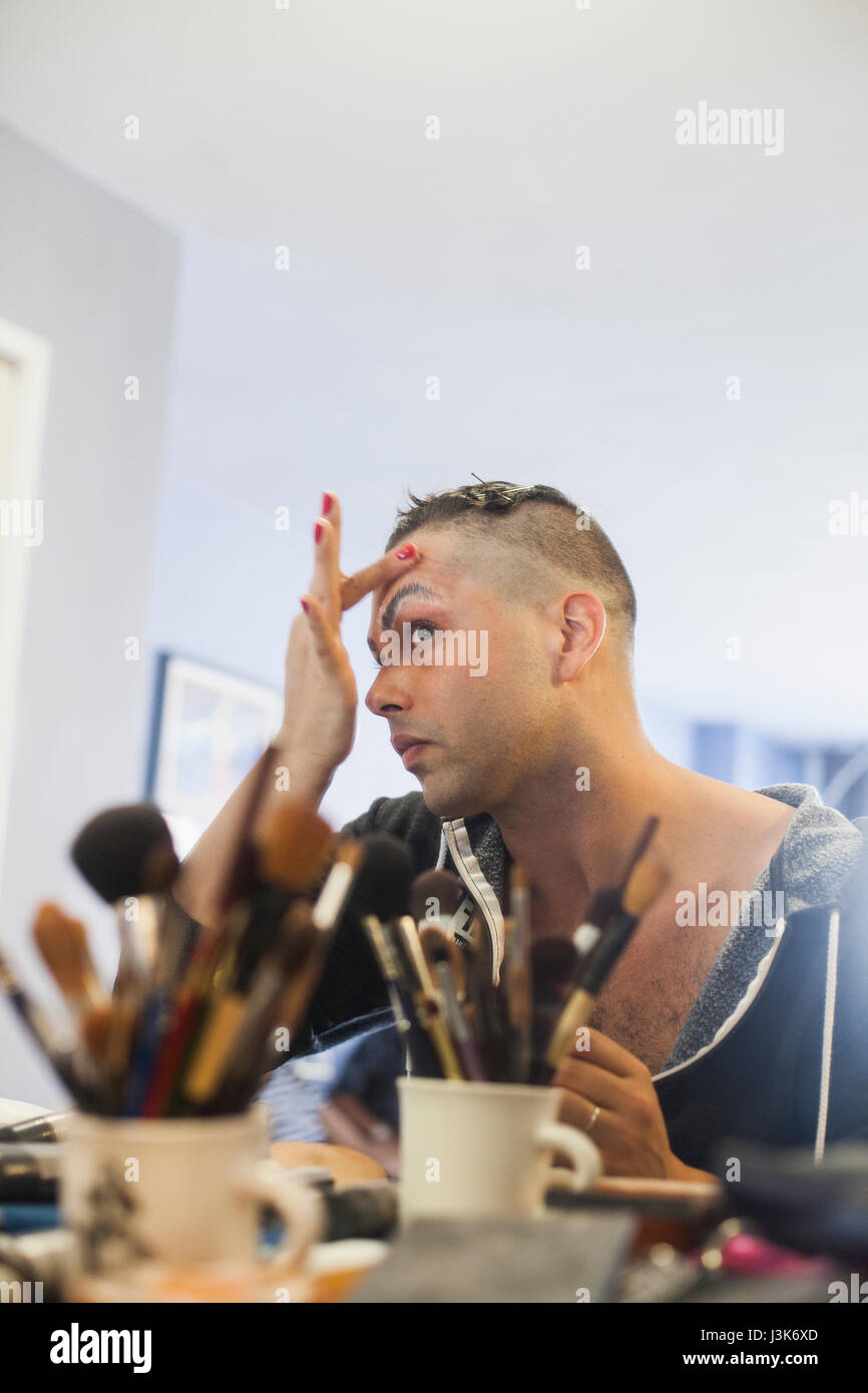 Young man applying drag makeup Stock Photo - Alamy