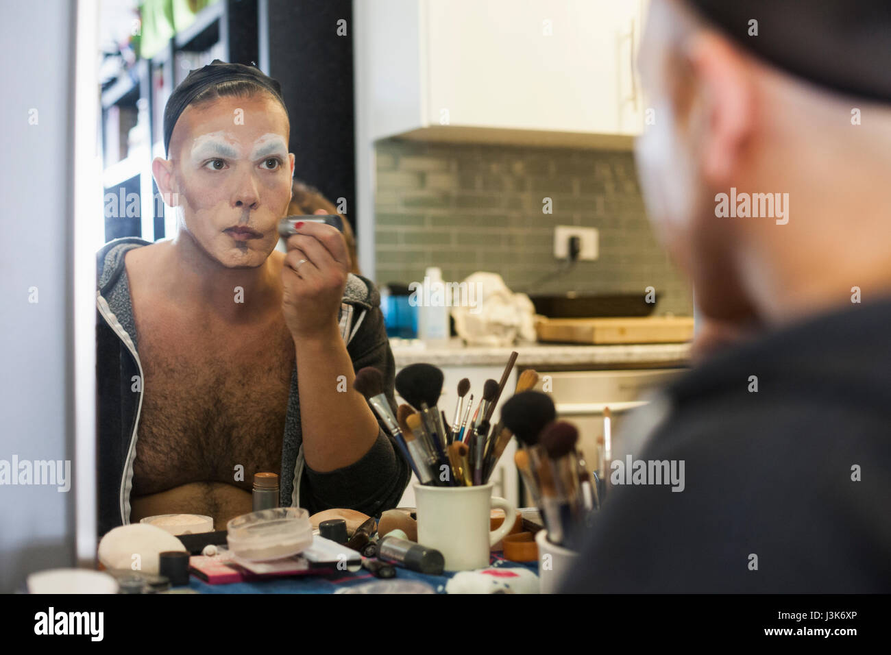 Young man applying drag makeup Stock Photo - Alamy