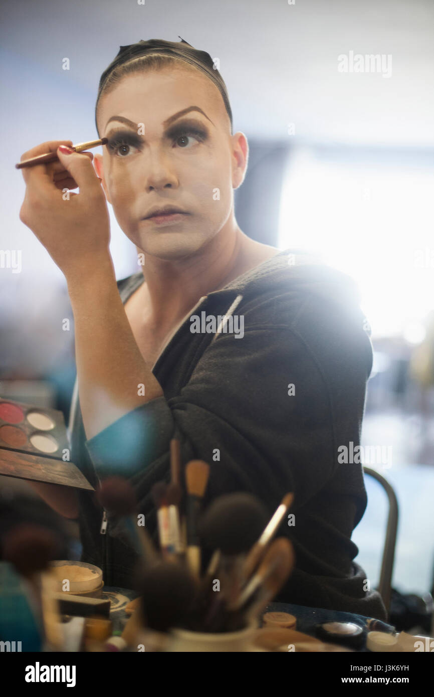 Young man applying drag makeup Stock Photo Alamy