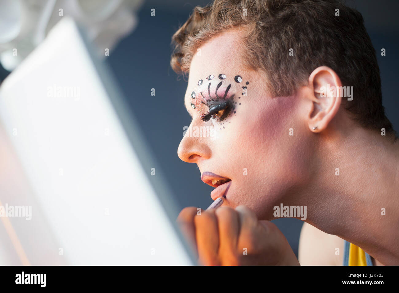 Young man applying drag makeup Stock Photo - Alamy