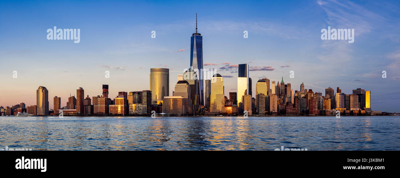 Panoramic of New York City Financial District skyscrapers and Hudson River at sunset. Lower Manhattan Stock Photo