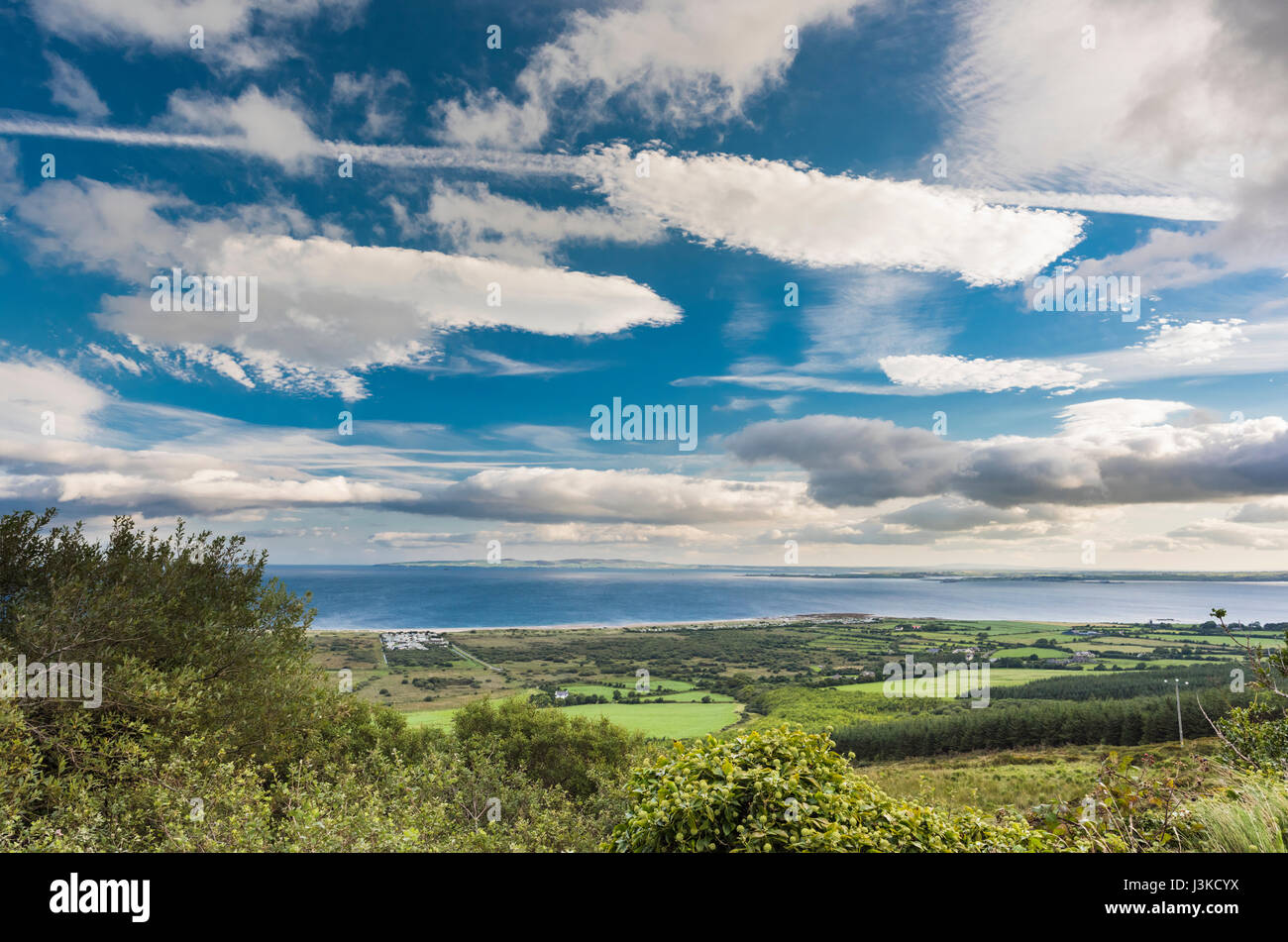 View northwards over Tralee Bay from above the village of Camp on the Dingle Peninsula, County Kerry, Ireland, with spectacular cloud formations Stock Photo