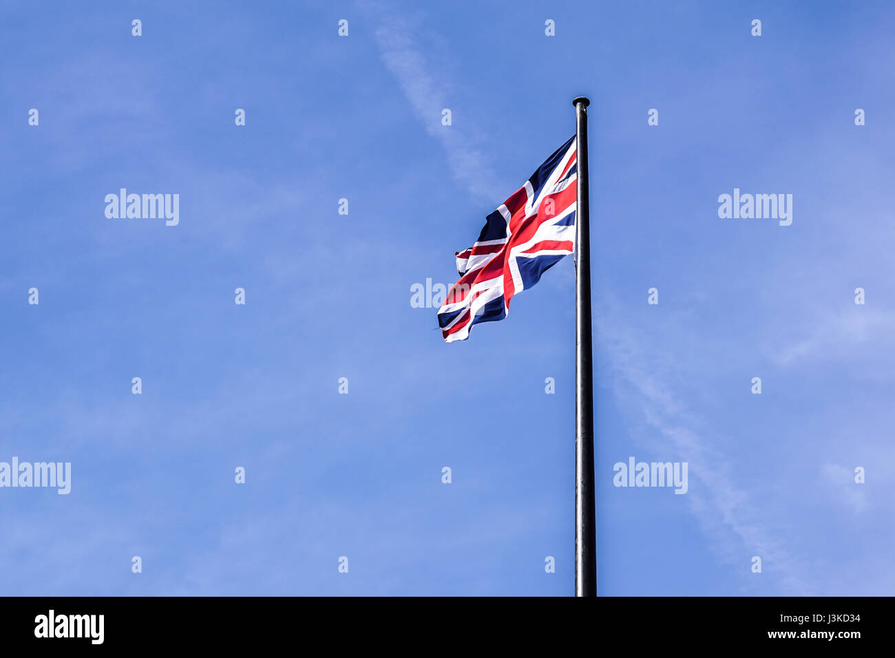 The British flag waving in the wind . Stock Photo