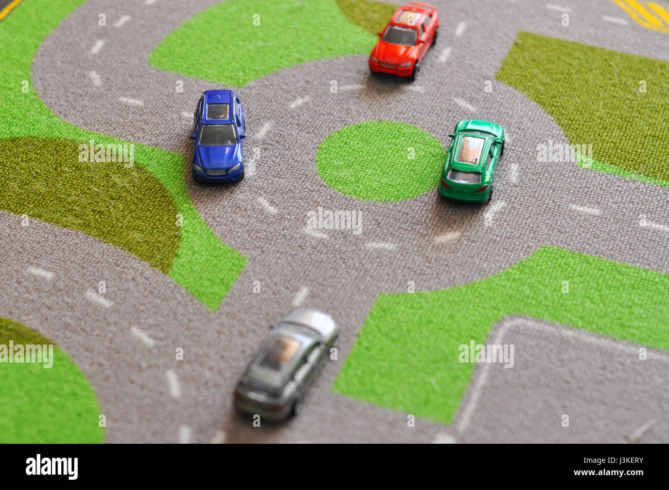Toy cars over a carpet circuit Stock Photo