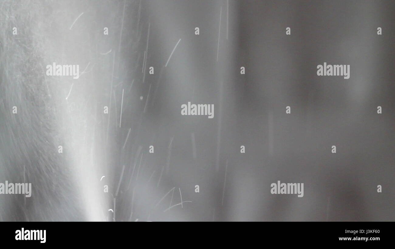 Aerosol can being sprayed against a grey background Stock Photo - Alamy