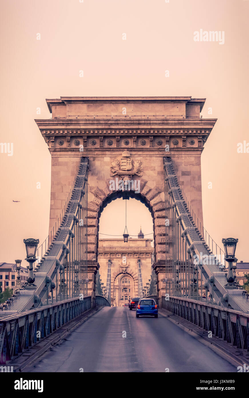 Cars drive over the historic Chain Bridge, which spans the River Danube in Budapest, the capital