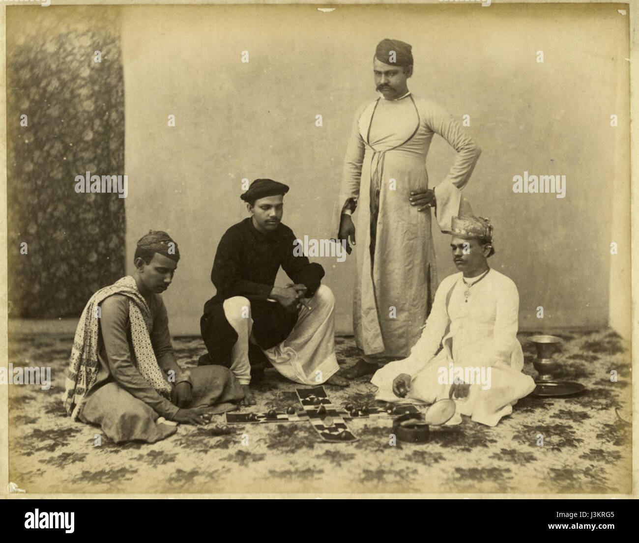 Group of Marwaree men playing chess actually pachisi a photo perhaps by Taurines, c.1880's Stock Photo