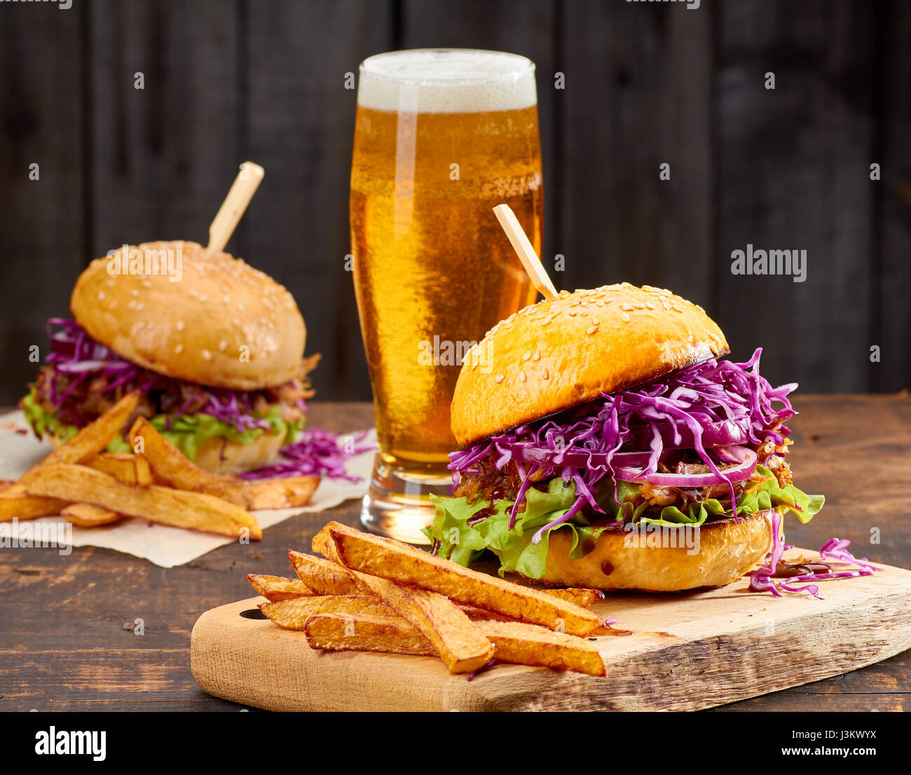 Two Sandwiches With Pulled Pork French Fries And Glass Of Beer On Stock Photo Alamy