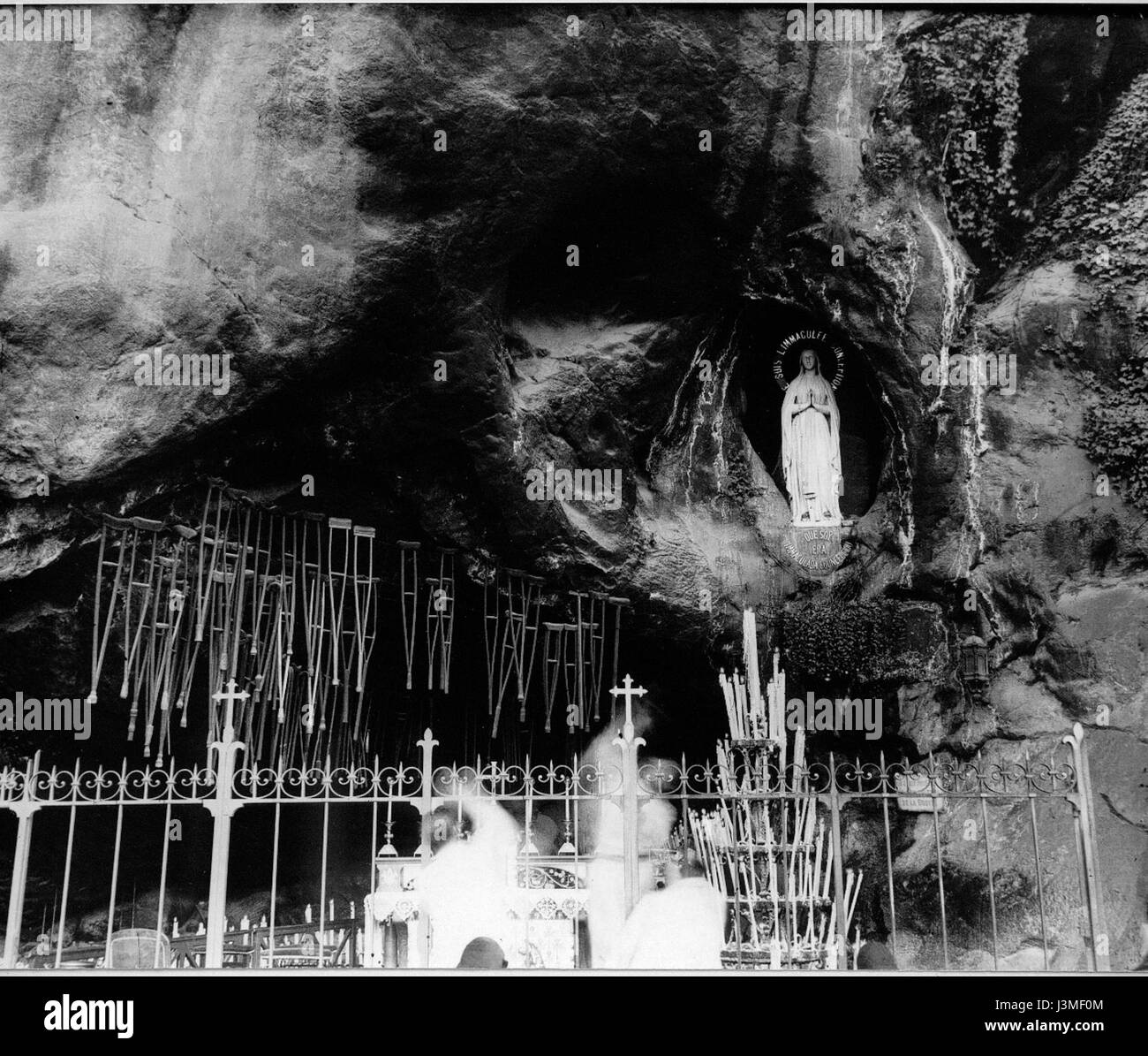The Grotto of Massabielle, located in Lourdes, France, is famous for being the site of Marian apparitions. The ex-voto offerings left by pilgrims reflect the site's deep spiritual significance. Stock Photo