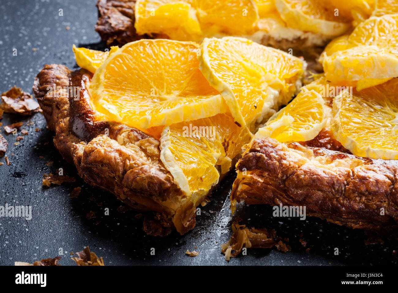Slice of tart with cottage cheese and sliced orange Stock Photo