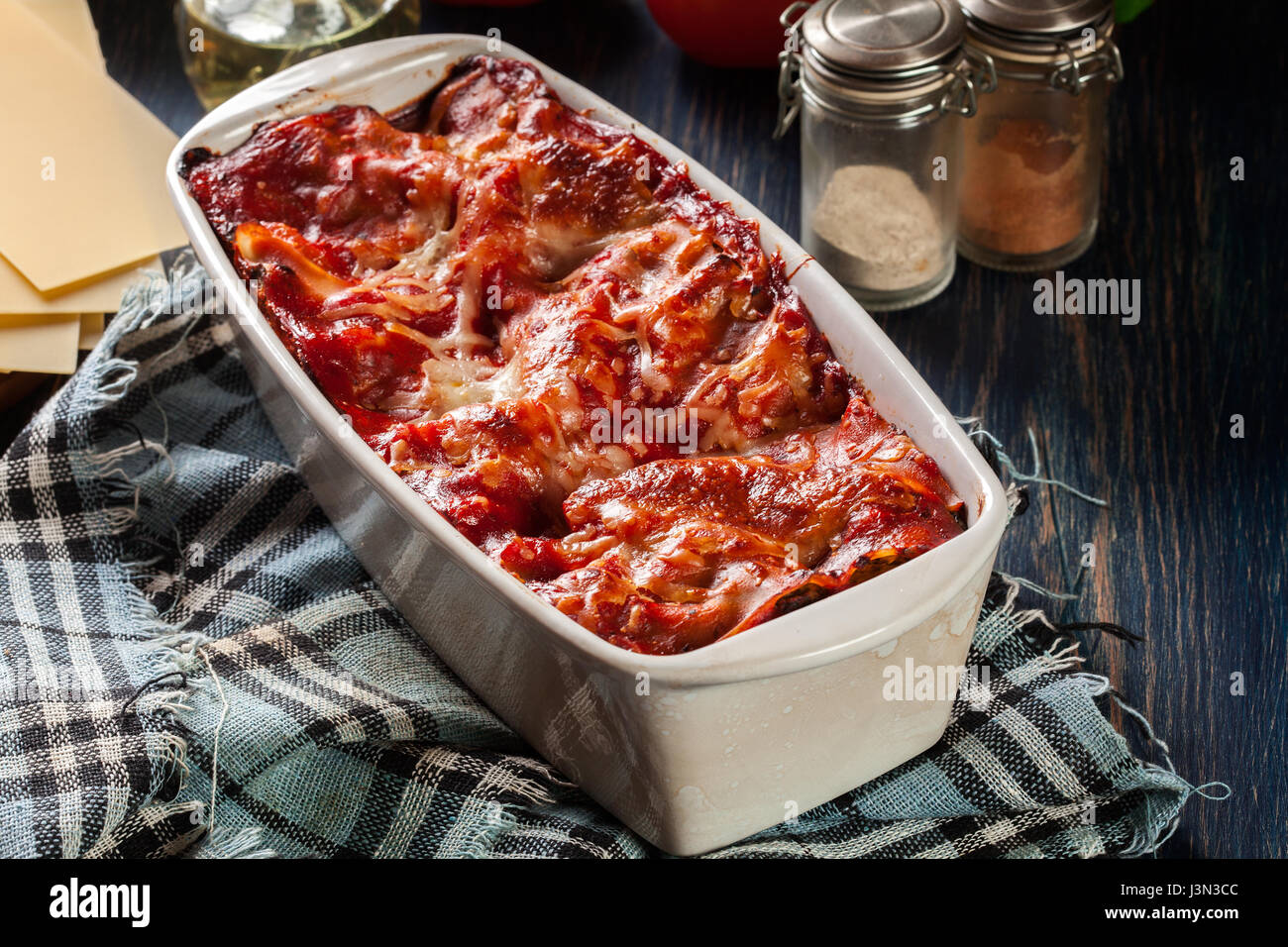 Hot tasty lasagna with spinach in ceramic casserole dish. Italian cuisine. Stock Photo