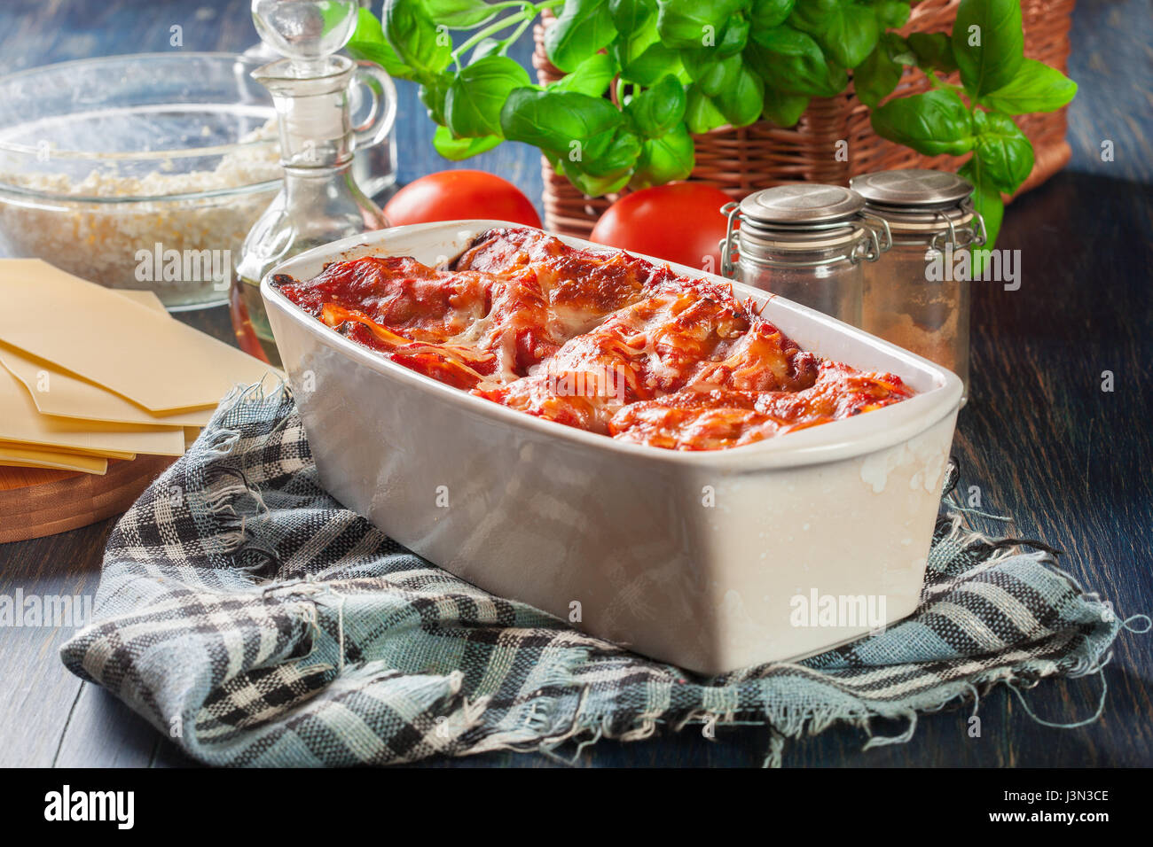 Hot tasty lasagna with spinach in ceramic casserole dish. Italian cuisine. Stock Photo